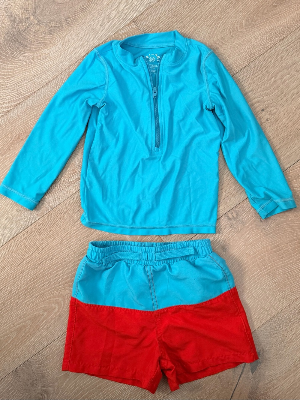 Primary Bright Teal Rash Guard with Red Swim Shorts